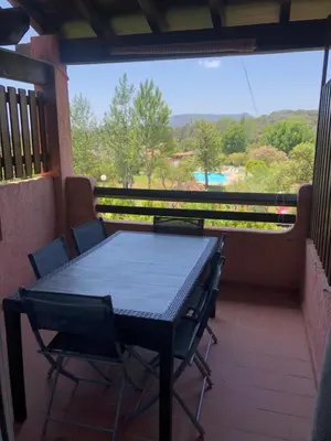 a table and chairs on a balcony with a view at Marina di pinarello, appt climatisé à 400m de la plage in Zonza