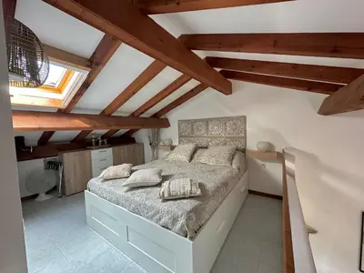 a bedroom with a bed in a room with wooden ceilings at Marina di pinarello, appt climatisé à 400m de la plage in Zonza