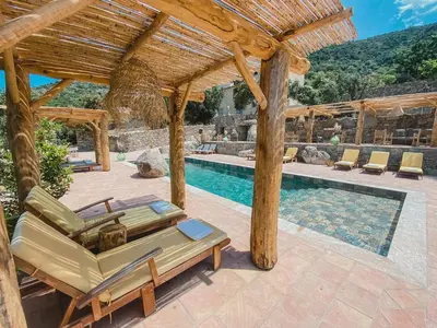 a swimming pool with a wooden pergola and lounge chairs at Résidence de Luxe 4 étoiles à Pietralba, 4 logements piscine chauffée BALAGNE in Pietralba