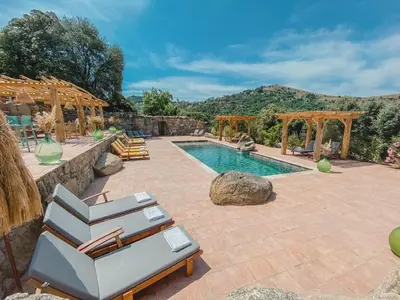 a swimming pool with lounge chairs next to a resort at Résidence de Luxe 4 étoiles à Pietralba, 4 logements piscine chauffée BALAGNE in Pietralba