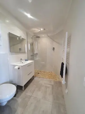 a bathroom with a toilet and a sink and a shower at Très belle Résidence vue mer et piscine chauffée - BACCALOCATION in Porto-Vecchio