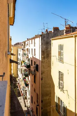 a view of an alley between two buildings at Hôtel Du Golfe in Ajaccio