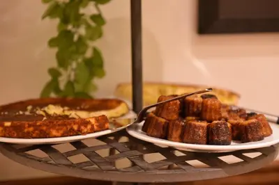 a table topped with two plates of food and bread at Les Jardins De La Glacière in Corte