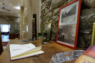 a room with a table with papers on it at Les Jardins De La Glacière in Corte