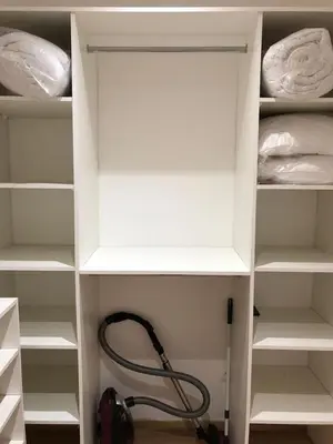 a white cabinet with a hose in a closet at T2 COSY EN PLEIN CENTRE HISTORIQUE D'AJACCIO in Ajaccio
