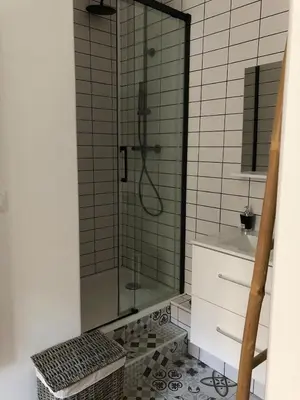 a bathroom with a glass shower and a sink at T2 COSY EN PLEIN CENTRE HISTORIQUE D'AJACCIO in Ajaccio