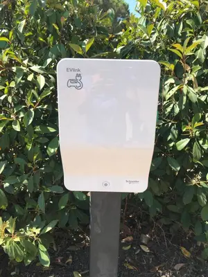 a white mailbox in front of a bush at Porto-Vecchio Baie Santa Giulia appartement une chambre 4-5 personnes in Porto-Vecchio