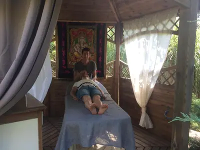 a man laying on a bed in a tree house at Levolle Marine in Poggio-Mezzana
