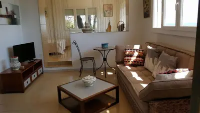 a living room with a couch and a table at Levolle Marine in Poggio-Mezzana