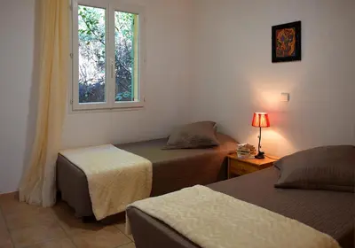 a bedroom with two beds and a window at Résidence Chiar' Di Luna in Sainte-Lucie de Porto-Vecchio