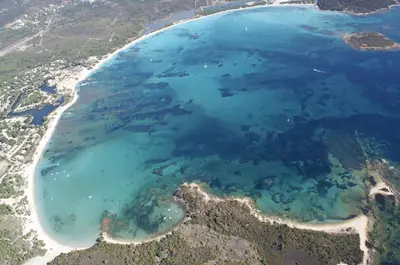 an aerial view of a beach with blue water at Résidence Chiar' Di Luna in Sainte-Lucie de Porto-Vecchio
