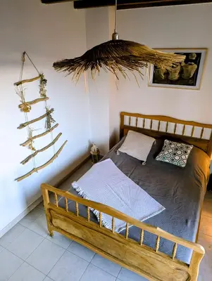 a bedroom with a bed with a wooden frame at MAISON TUCCARELLU in Letia