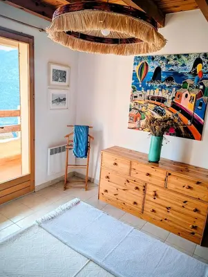a room with a wooden dresser and a painting on the wall at MAISON TUCCARELLU in Letia