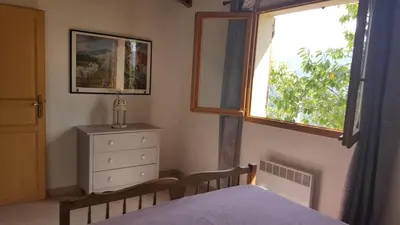 a bedroom with a bed and a window and a dresser at MAISON TUCCARELLU in Letia