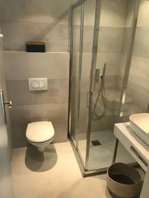 a bathroom with a toilet and a glass shower at Maison Ferruccio in Porto-Vecchio