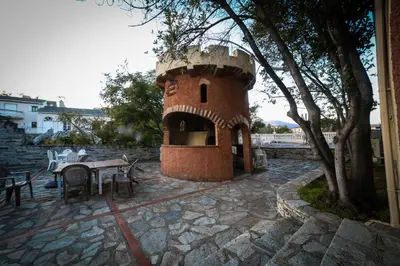 a small brick tower with a table and chairs at Castellu Rossu in Lucciana