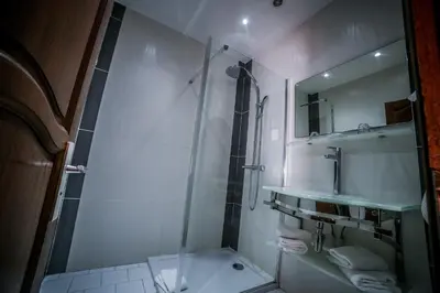 a bathroom with a shower and a sink and a mirror at Castellu Rossu in Lucciana