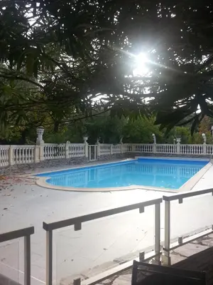 a swimming pool with a white fence around it at Castellu Rossu in Lucciana