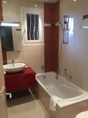a bathroom with a tub and a sink and a bath tub at Castellu Rossu in Lucciana