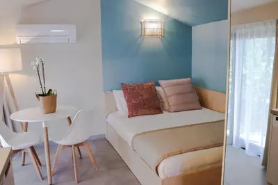 a small room with a bed and a table at Résidence Mobydick in Porto-Vecchio