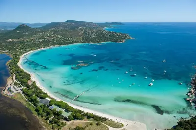 an aerial view of a beach with boats in the water at Résidence Cala Sultana in Porto-Vecchio