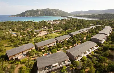 an aerial view of a resort with houses and the water at Résidence Cala Sultana in Porto-Vecchio