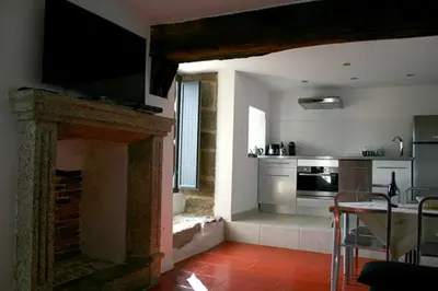 a living room with a fireplace with a television on top at Casa Giacometti in Grosseto-Prugna