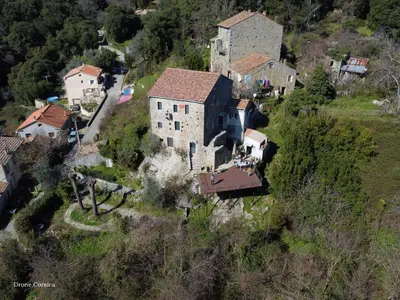 an old house on the side of a mountain at Casa Giacometti in Grosseto-Prugna