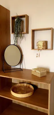 a mirror and a bowl on a wooden shelf at Hotel Scandola in Piana