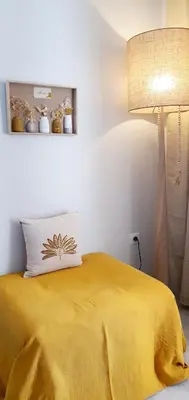 a bedroom with a yellow bed with a lamp at Hotel Scandola in Piana