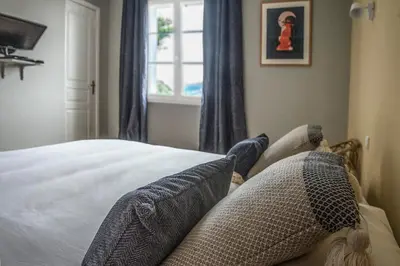a bedroom with a bed with pillows and a window at Casa Vanella in Casamaccioli