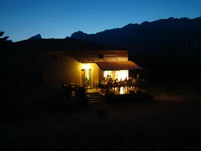 a small house with a lit up room at night at Casa Vanella in Casamaccioli