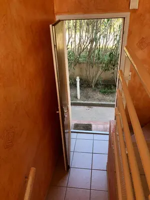 an open door to a room with a view of a yard at PORTICCIO, AGOSTA PLAGE vue mer pour 6 p, 2 ch, PROMO 7 nuits in Porticcio
