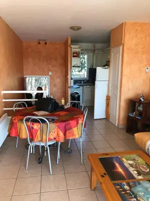 a kitchen and dining room with a table and a refrigerator at PORTICCIO, AGOSTA PLAGE vue mer pour 6 p, 2 ch, PROMO 7 nuits in Porticcio