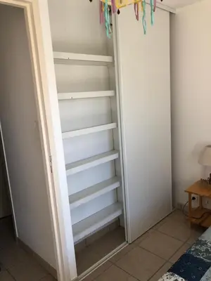 a walk in closet with white shelves at PORTICCIO, AGOSTA PLAGE vue mer pour 6 p, 2 ch, PROMO 7 nuits in Porticcio