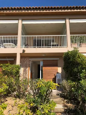 a house with a balcony on the side of it at PORTICCIO, AGOSTA PLAGE vue mer pour 6 p, 2 ch, PROMO 7 nuits in Porticcio