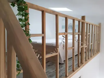 a wooden staircase with a view of the ocean at Mini-villa 1 MER in Porto-Vecchio