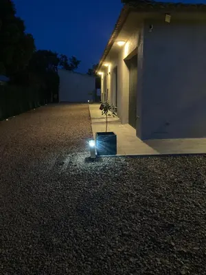 a plant in a pot on a gravel driveway at night at Mini-villa 1 MER in Porto-Vecchio