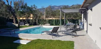 a patio with chairs and a swimming pool at Mini-villa 1 MER in Porto-Vecchio