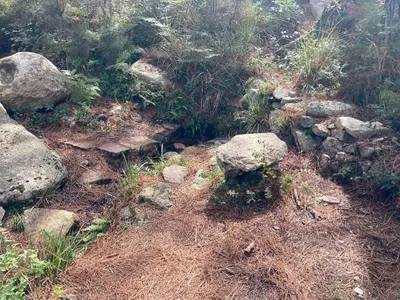 a pile of rocks and plants on a hill at Mini-villa 2 MONTAGNE in Porto-Vecchio