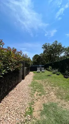 a bench sitting in a yard with a fence at Mini-villa 2 MONTAGNE in Porto-Vecchio