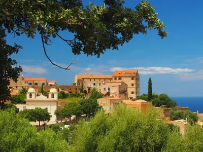 a village on a hill with the ocean in the background at Villa in Moriani-Plage near Sandy Beach in San-Nicolao