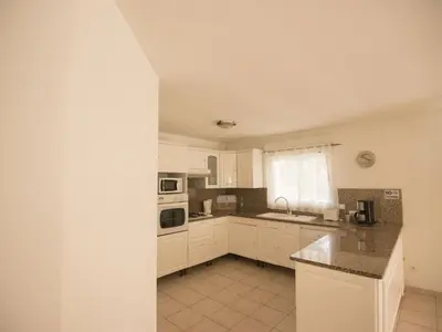 a kitchen with white cabinets and a counter top at Villa in Moriani-Plage near Sandy Beach in San-Nicolao