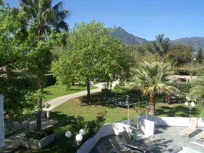 a view of a park with palm trees and a path at Apartment in Moriani-Plage near the Beach in San-Nicolao