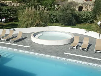 a swimming pool with lounge chairs and a swimming pool at Apartment in Moriani-Plage near the Beach in San-Nicolao