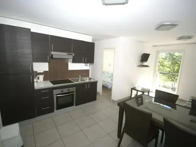 a kitchen with a table with a laptop on it at Apartment in Moriani-Plage near the Beach in San-Nicolao