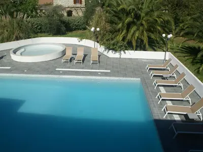 a swimming pool with lounge chairs and a swimming pool at Apartment in Moriani-Plage by the Beach in San-Nicolao