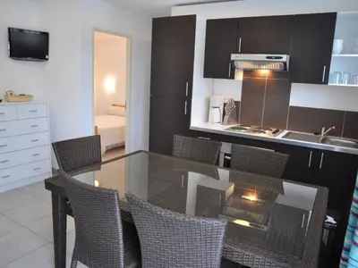 a kitchen with a table and chairs in a kitchen at Apartment in Moriani-Plage by the Beach in San-Nicolao