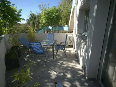 a patio with chairs and a table and a fence at Apartment in Moriani-Plage by the Beach in San-Nicolao