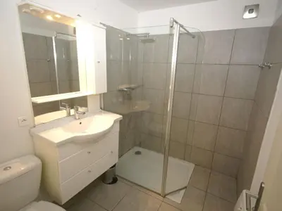 a bathroom with a shower and a sink and a toilet at Apartment in Moriani-Plage by the Beach in San-Nicolao